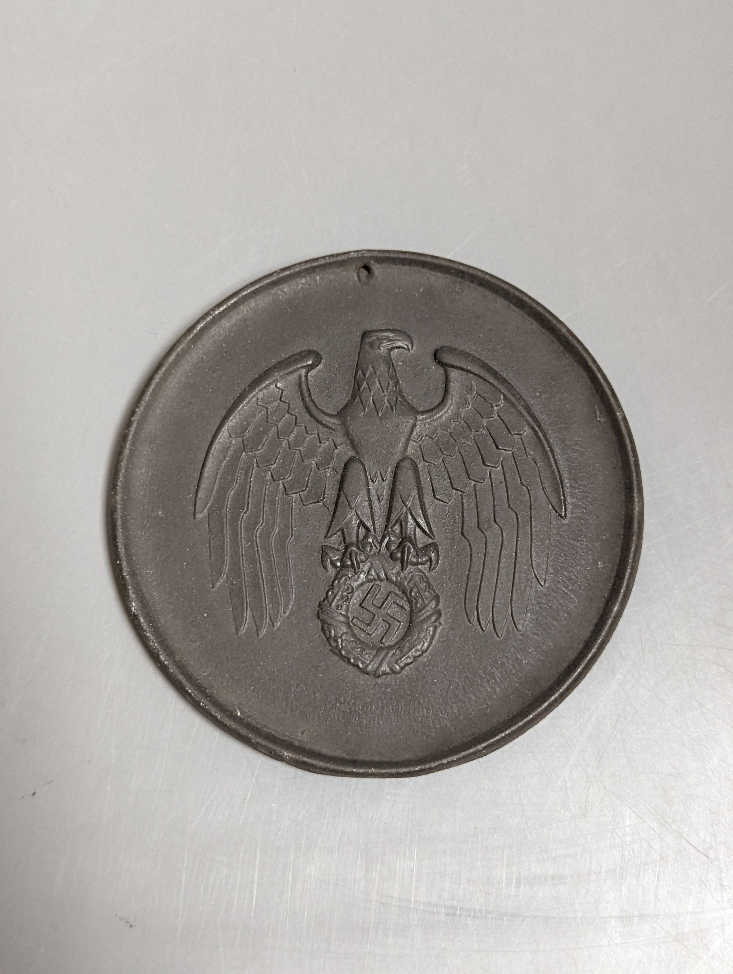 A scarce cased bisque porcelain German medallion, awarded to the winner of the summer solstice competition, 1939 (decorated with SS rune script reading Dem, Sieger Im Sommer-Sonnenwendwettkampf, 1939). In original box.